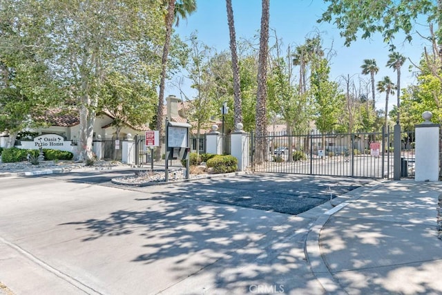 37940 42nd St E Unit 125, Palmdale, CA 93552 - view of concrete street featuring a gate, a gated entry, and curbs
