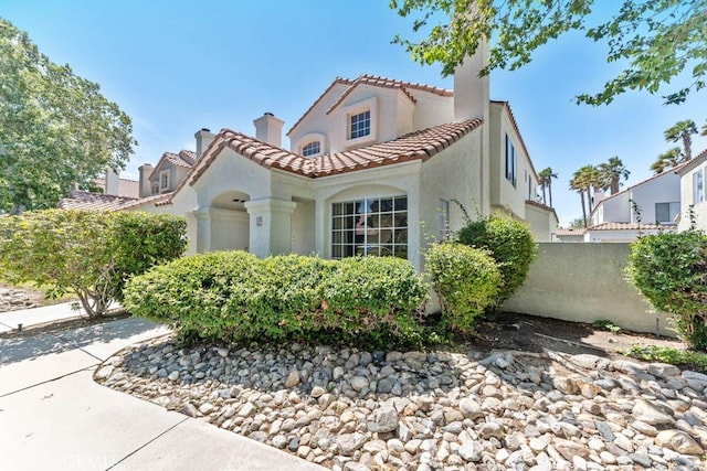 37940 42nd St E Unit 125, Palmdale, CA 93552 - mediterranean / spanish house featuring stucco siding, a tile roof, and a chimney