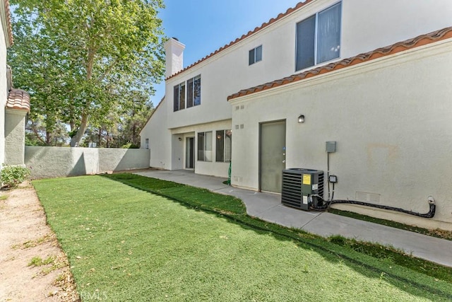 37940 42nd St E Unit 125, Palmdale, CA 93552 - rear view of house featuring cooling unit, stucco siding, a chimney, and a tiled roof
