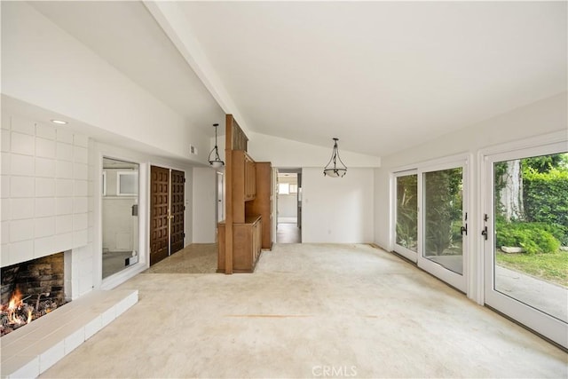 390 Peralta Ave, Long Beach, CA 90803 - unfurnished living room featuring lofted ceiling, light colored carpet, and a brick fireplace