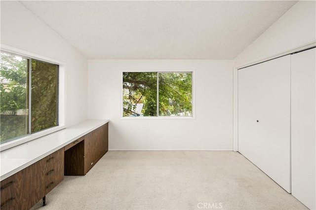 390 Peralta Ave, Long Beach, CA 90803 - unfurnished bedroom featuring light carpet, a desk, a closet, and vaulted ceiling