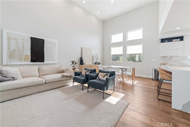 2713 Carnegie Ln Unit B, Redondo Beach, CA 90278 - living room featuring high vaulted ceiling, light wood-type flooring, recessed lighting, and baseboards