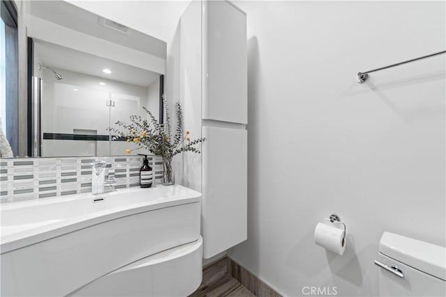 2713 Carnegie Ln Unit B, Redondo Beach, CA 90278 - full bathroom with toilet, vanity, a shower stall, backsplash, and wood finished floors