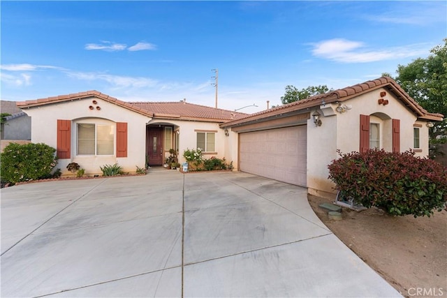 39202 Nicole Dr, Palmdale, CA 93551 - mediterranean / spanish house featuring concrete driveway, an attached garage, a tile roof, and stucco siding