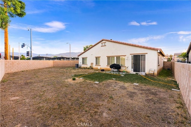 39202 Nicole Dr, Palmdale, CA 93551 - rear view of property featuring stucco siding, a fenced backyard, a tiled roof, and a mountain view