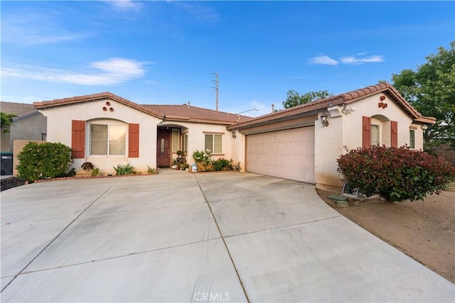 39202 Nicole Dr, Palmdale, CA 93551 - mediterranean / spanish home featuring driveway, an attached garage, a tile roof, and stucco siding