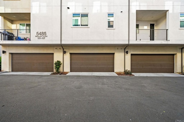 5485 Seacliff Pl Unit 106, San Diego, CA 92154 - view of front of house with a garage and stucco siding