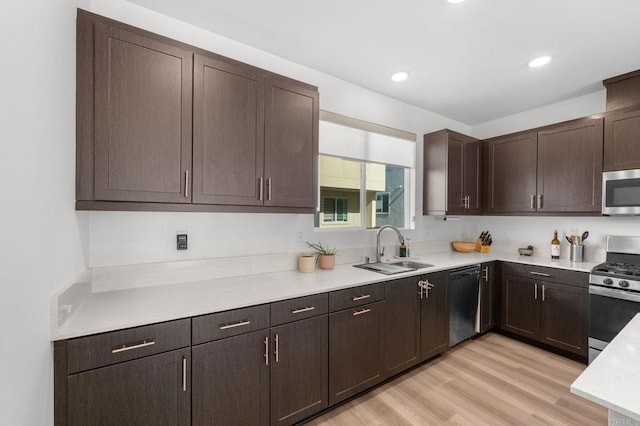 5485 Seacliff Pl Unit 106, San Diego, CA 92154 - kitchen featuring stainless steel appliances, a sink, light countertops, dark brown cabinets, and light wood finished floors