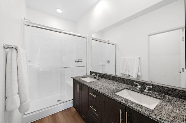 5485 Seacliff Pl Unit 106, San Diego, CA 92154 - full bath featuring a shower stall, wood finished floors, and double vanity