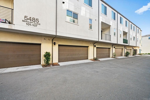 5485 Seacliff Pl Unit 106, San Diego, CA 92154 - view of property featuring a garage