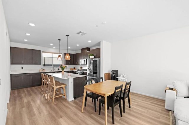 5485 Seacliff Pl Unit 106, San Diego, CA 92154 - dining room with light wood finished floors, recessed lighting, and baseboards