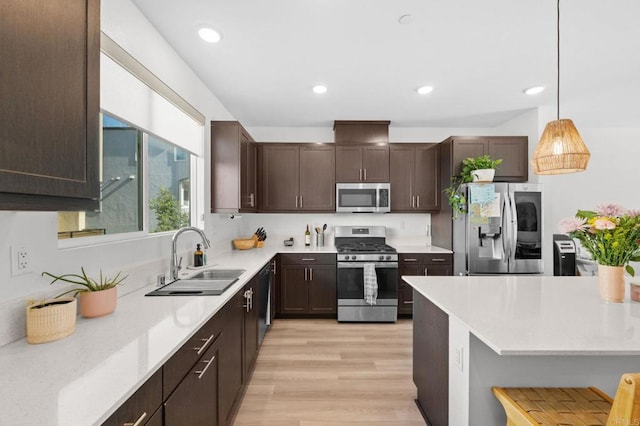 5485 Seacliff Pl Unit 106, San Diego, CA 92154 - kitchen with stainless steel appliances, a sink, dark brown cabinetry, light countertops, and recessed lighting