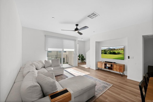 5485 Seacliff Pl Unit 106, San Diego, CA 92154 - living area featuring plenty of natural light, wood finished floors, ceiling fan, and baseboards