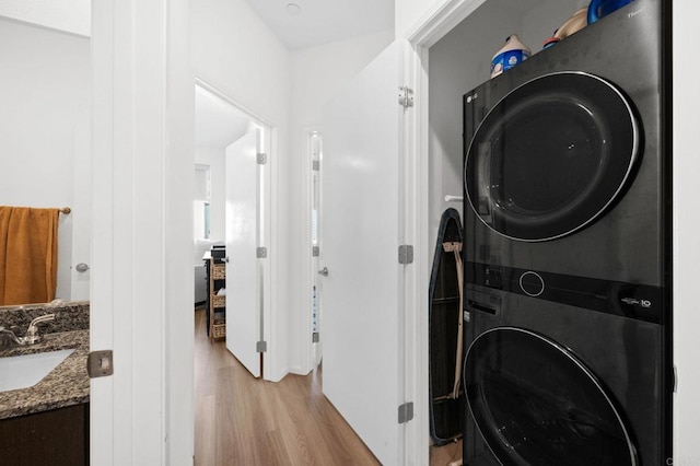 5485 Seacliff Pl Unit 106, San Diego, CA 92154 - laundry room with stacked washer / drying machine and light wood finished floors
