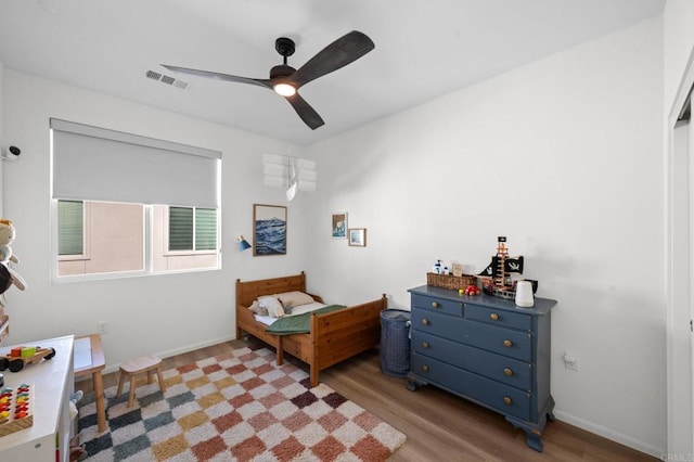 5485 Seacliff Pl Unit 106, San Diego, CA 92154 - bedroom with wood finished floors, a ceiling fan, and baseboards