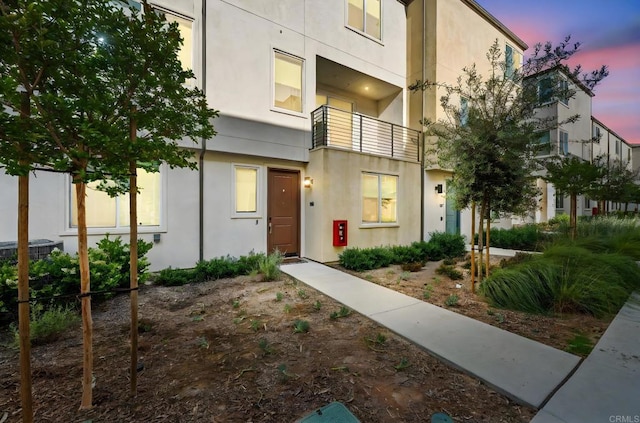 5485 Seacliff Pl Unit 106, San Diego, CA 92154 - view of front of property featuring stucco siding, a balcony, and central AC