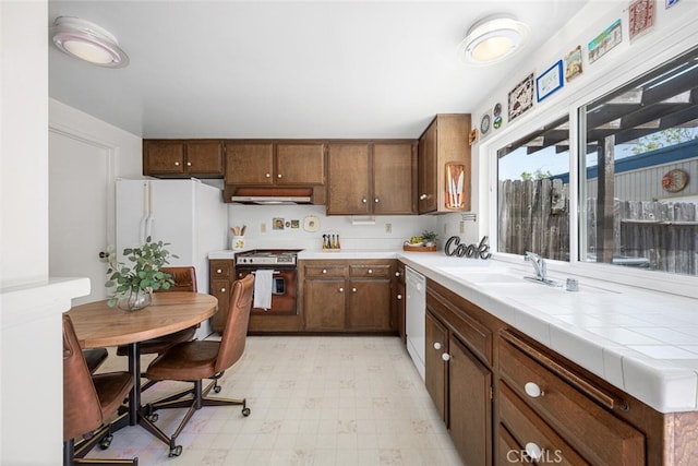 4418 Larwin Ave, Cypress, CA 90630 - kitchen featuring white appliances, light flooring, and exhaust hood