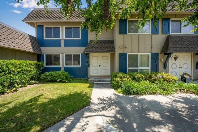 4418 Larwin Ave, Cypress, CA 90630 - view of property featuring a front yard, board and batten siding, and a shingled roof