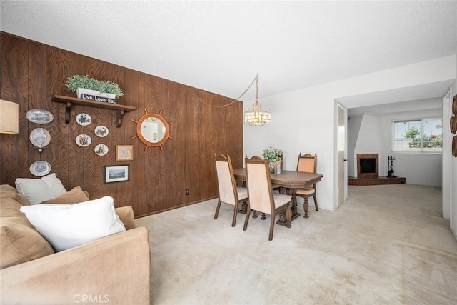 4418 Larwin Ave, Cypress, CA 90630 - dining area featuring wood walls, carpet floors, a chandelier, and a fireplace