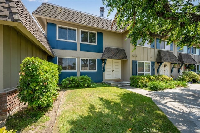 4418 Larwin Ave, Cypress, CA 90630 - view of property featuring a front lawn, board and batten siding, and stucco siding