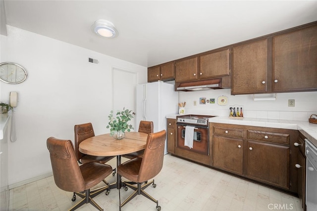 4418 Larwin Ave, Cypress, CA 90630 - kitchen featuring light flooring, stainless steel appliances, under cabinet range hood, and dark brown cabinets