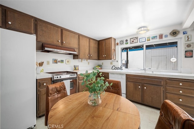 4418 Larwin Ave, Cypress, CA 90630 - kitchen with white appliances, under cabinet range hood, light floors, and tile countertops