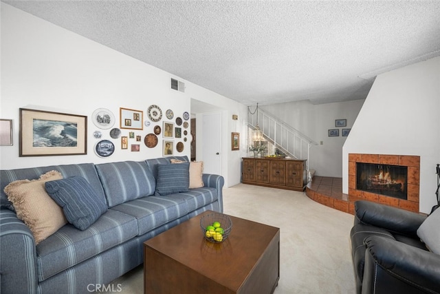 4418 Larwin Ave, Cypress, CA 90630 - carpeted living room featuring stairs, a textured ceiling, and a tile fireplace