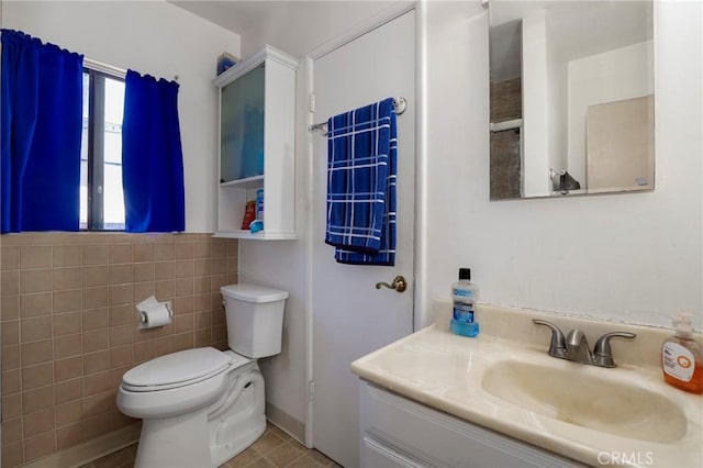 1716 N Fries Ave, Wilmington, CA 90744 - bathroom featuring vanity, toilet, and tile walls