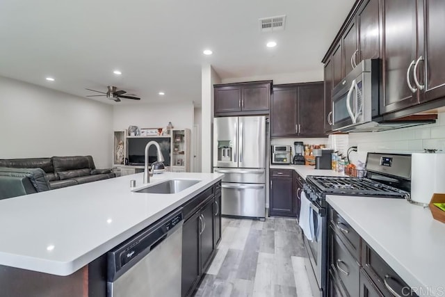 13217 Midnight Star Way, Lakeside, CA 92040 - kitchen featuring appliances with stainless steel finishes, a sink, light countertops, a ceiling fan, and open floor plan