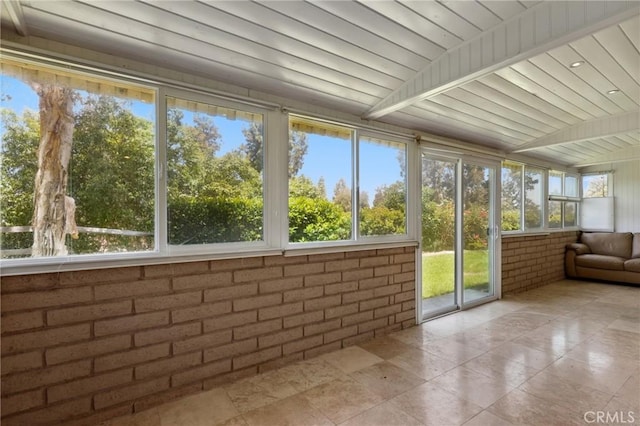 3413 Punta Alta Unit A, Laguna Woods, CA 92637 - unfurnished sunroom featuring brick wall, plenty of natural light, and tile patterned flooring