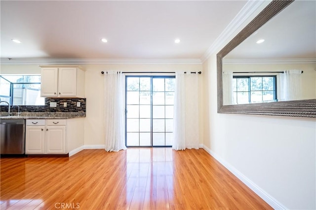 10894 Olinda St Unit 116, Sun Valley, CA 91352 - kitchen featuring dishwasher, light wood-style flooring, white cabinets, baseboards, and tasteful backsplash