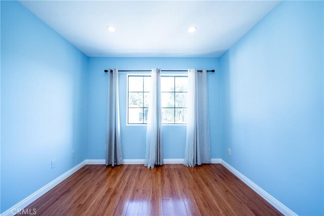 10894 Olinda St Unit 116, Sun Valley, CA 91352 - spare room featuring dark wood-style floors, baseboards, and recessed lighting