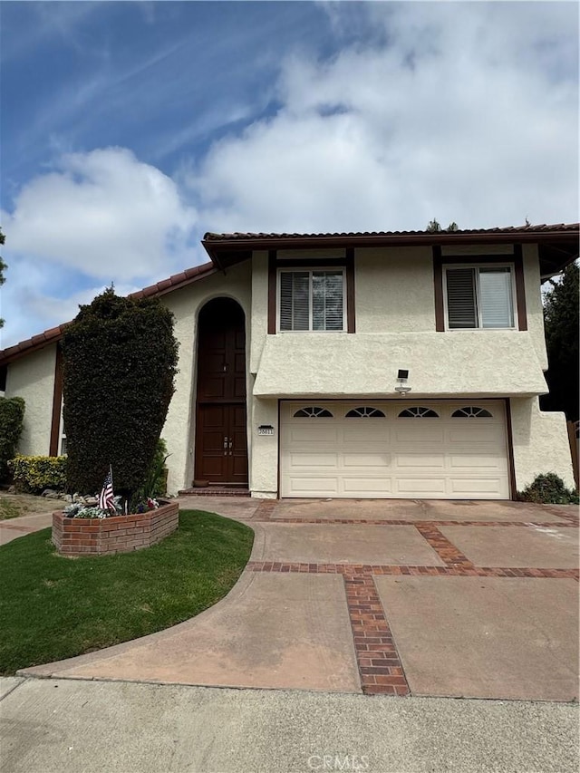 26611 Loma Verde, Mission Viejo, CA 92691 - view of front of house with an attached garage, concrete driveway, stucco siding, and a tiled roof