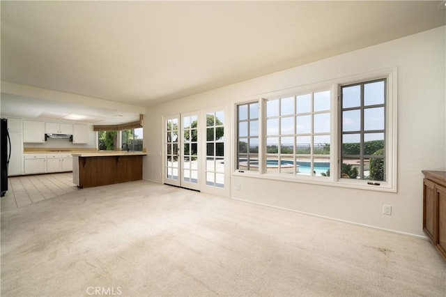 26611 Loma Verde, Mission Viejo, CA 92691 - unfurnished living room with light carpet, baseboards, and a sink