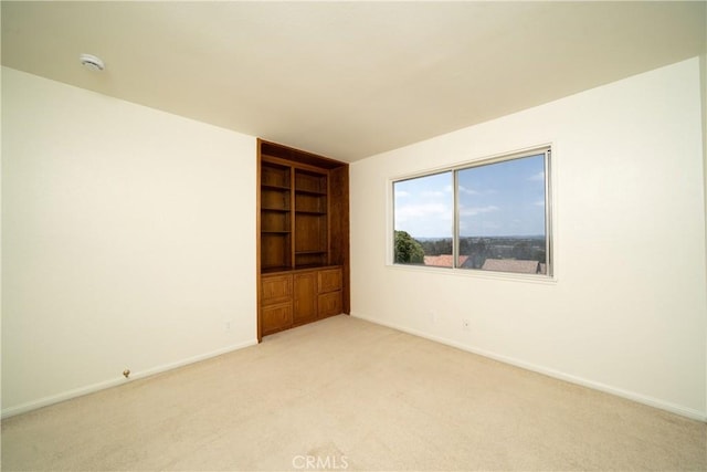 26611 Loma Verde, Mission Viejo, CA 92691 - unfurnished room featuring built in shelves, light carpet, and baseboards