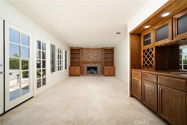 26611 Loma Verde, Mission Viejo, CA 92691 - unfurnished living room featuring light colored carpet, a fireplace, and built in shelves
