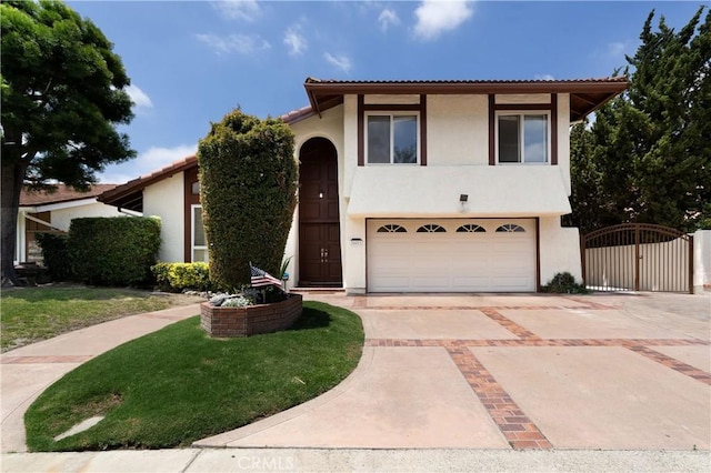 26611 Loma Verde, Mission Viejo, CA 92691 - view of front facade featuring a gate, stucco siding, an attached garage, driveway, and a tile roof