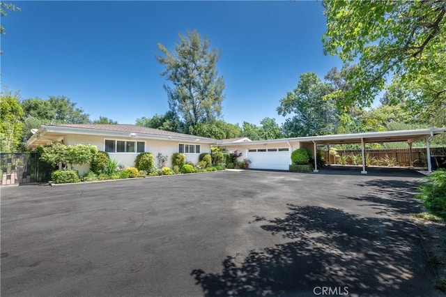 16303 Meadowridge Rd, Encino, CA 91436 - ranch-style home with a garage, stucco siding, asphalt driveway, and a carport