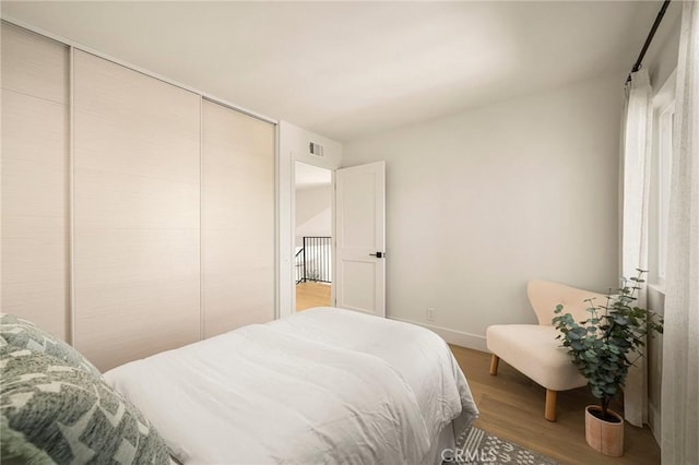 13 Lucero W, Irvine, CA 92620 - bedroom with wood finished floors, a closet, and baseboards
