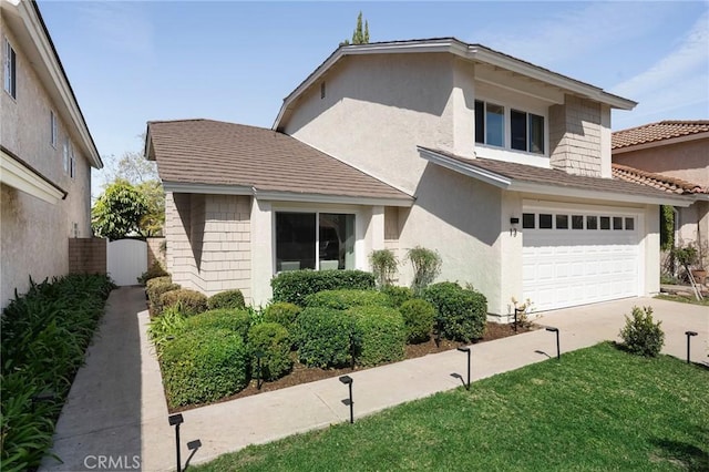 13 Lucero W, Irvine, CA 92620 - view of front of property featuring an attached garage, driveway, and stucco siding