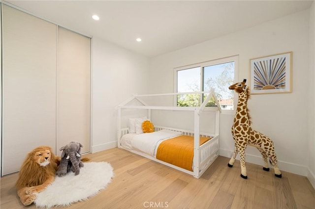13 Lucero W, Irvine, CA 92620 - bedroom with light wood-style floors, a closet, recessed lighting, and baseboards