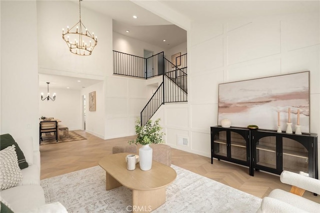 13 Lucero W, Irvine, CA 92620 - living area with a chandelier, stairway, a high ceiling, and recessed lighting
