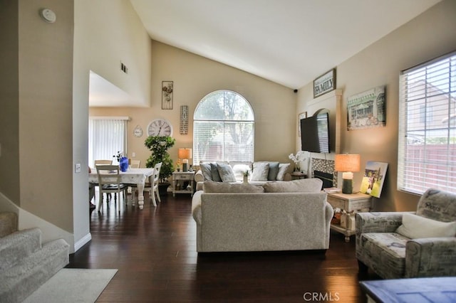 138 Greenhedge Ln, Pomona, CA 91766 - living area featuring lofted ceiling, healthy amount of natural light, dark wood-style flooring, and a fireplace