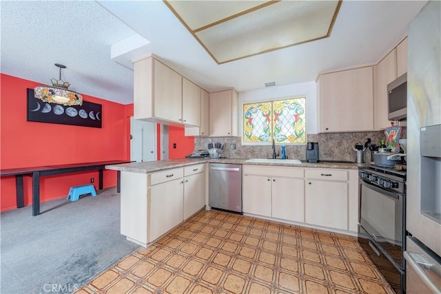 17915 Los Vasos St, Fountain Valley, CA 92708 - kitchen featuring appliances with stainless steel finishes, a sink, a peninsula, light countertops, and decorative backsplash