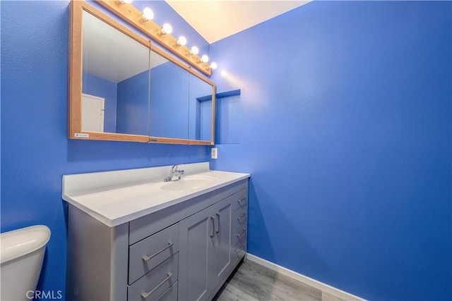 17915 Los Vasos St, Fountain Valley, CA 92708 - bathroom with vanity, toilet, wood finished floors, and baseboards
