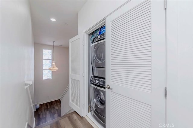 9213 Sunshine Pl, Downey, CA 90240 - washroom with stacked washing machine and dryer, light wood-style floors, baseboards, and recessed lighting