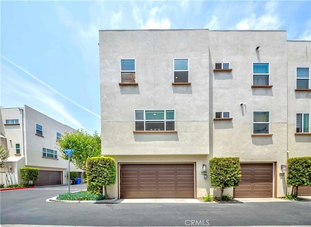 9213 Sunshine Pl, Downey, CA 90240 - view of property with stucco siding and an attached garage