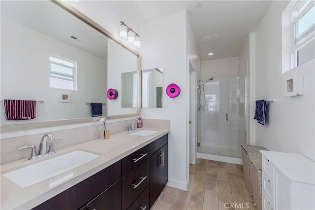 9213 Sunshine Pl, Downey, CA 90240 - full bathroom with double vanity, a shower stall, and wood finished floors