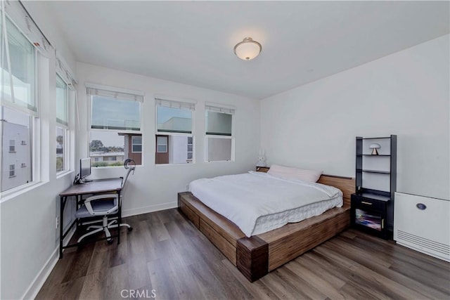 9213 Sunshine Pl, Downey, CA 90240 - bedroom with wood finished floors, baseboards, and a desk