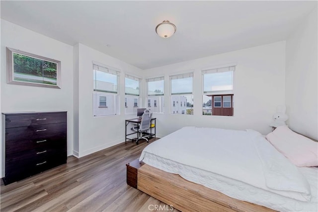9213 Sunshine Pl, Downey, CA 90240 - bedroom featuring multiple windows, wood finished floors, and baseboards